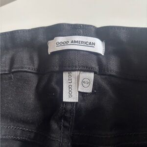 Good American Black denim jeans with tag visible